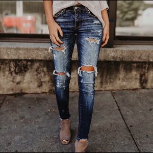 Distressed skinny ankle jeans in dark wash